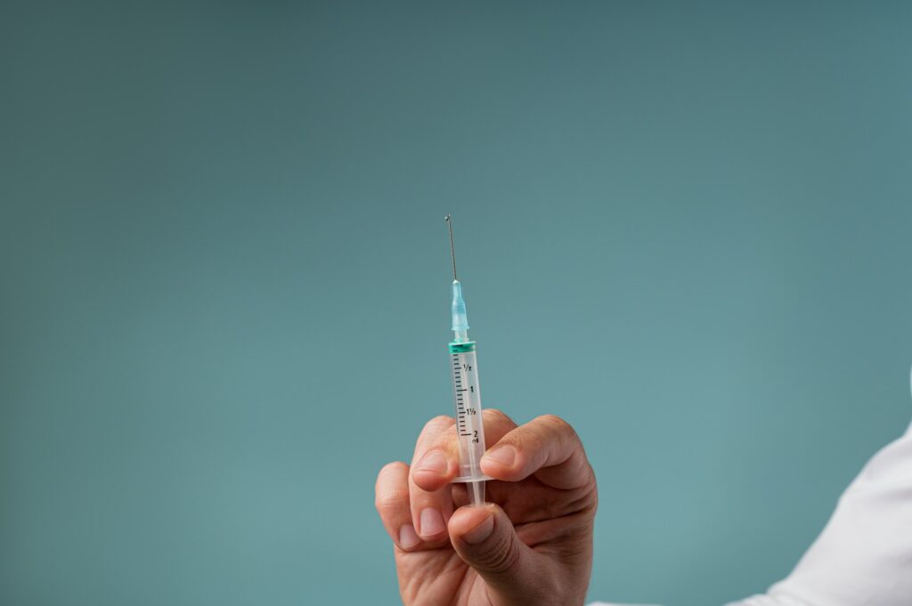 Doctor holding an injection with a needle